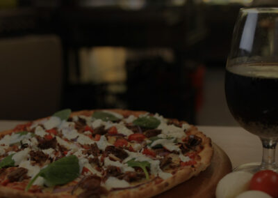 Greek lamb pizza with wine at Pitsa Pizza Mascot